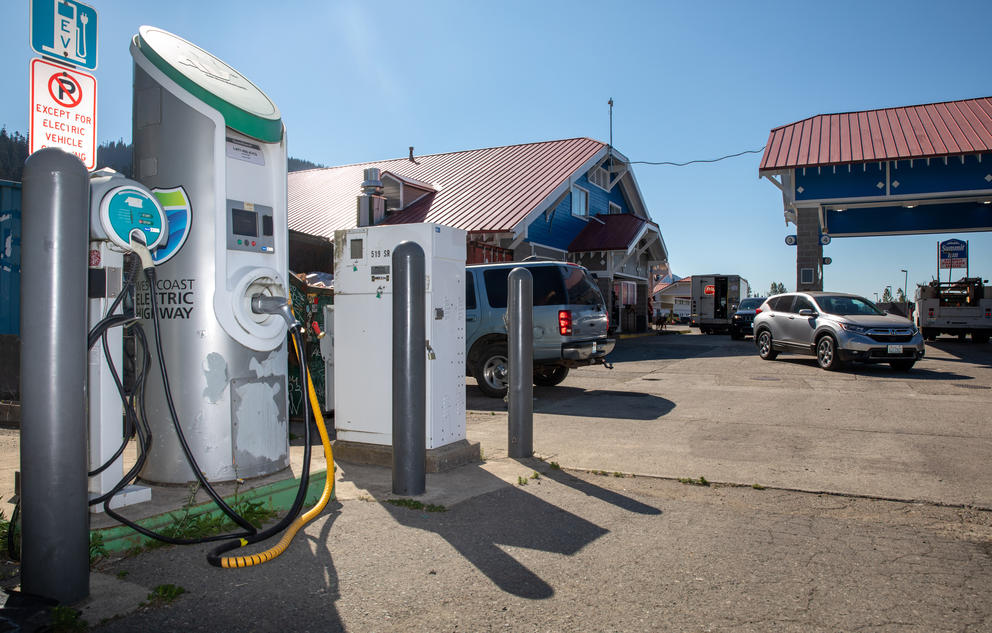An electric vehicle charger stands near a gas station in Snoqualmie Pass. 