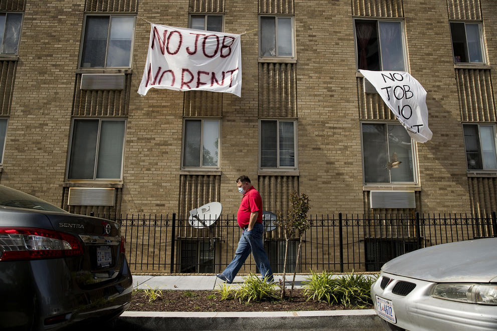 signs hanging from an apartment building