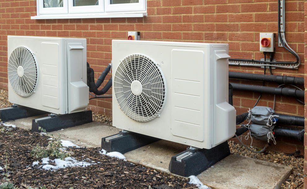 Heat pumps outside of a brick building