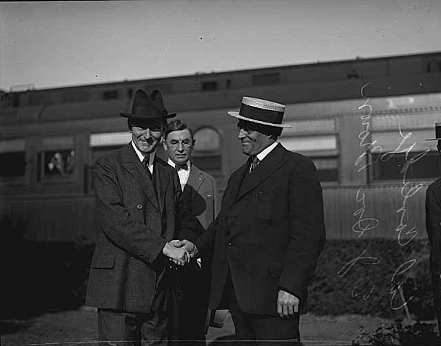 Two men in hats shaking hands