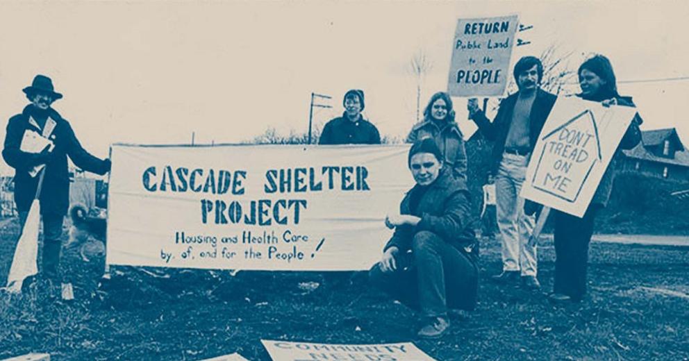 People holding signs in black and white image