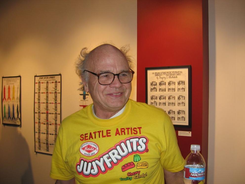 photo of a man in glasses wearing a "seattle artist jujyfruits" t-shirt