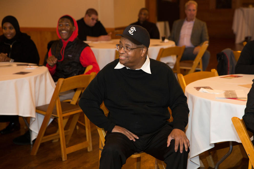 Larry Gossett sits with his hands on his knees, listening.