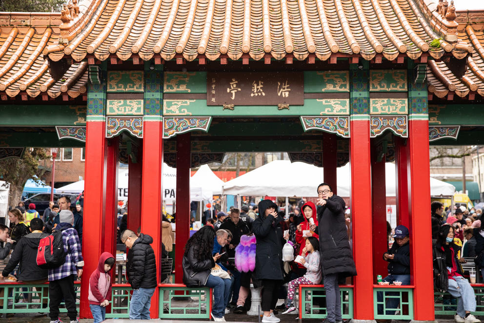 People sit under a Chinese style pagoda