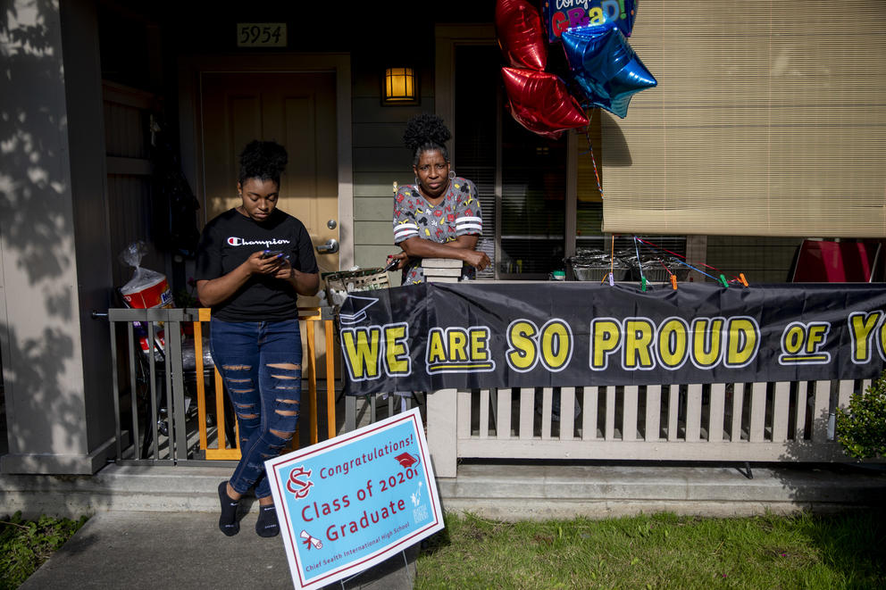 Camaree McGhee texts on her phone next to her mother Andrea Haynes 