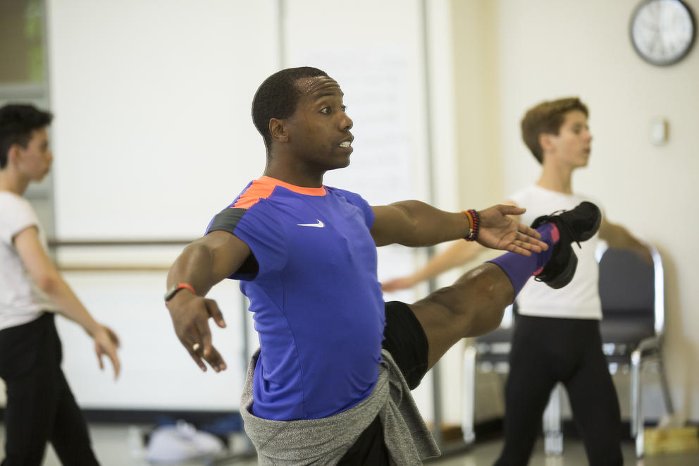 photo of a man rehearsing a dance in a ballet studio