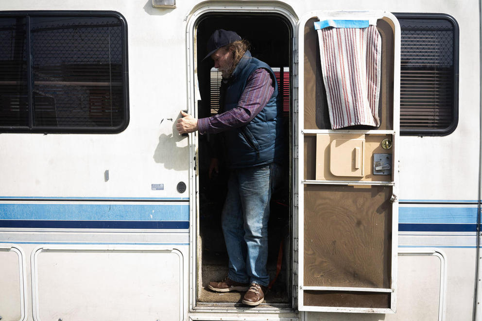 Neal Lampi steps out of his white RV