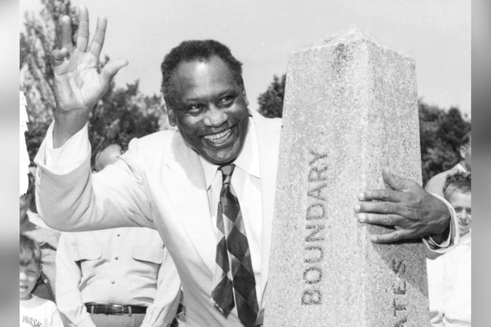 Paul Robeson at a marker at the international border.