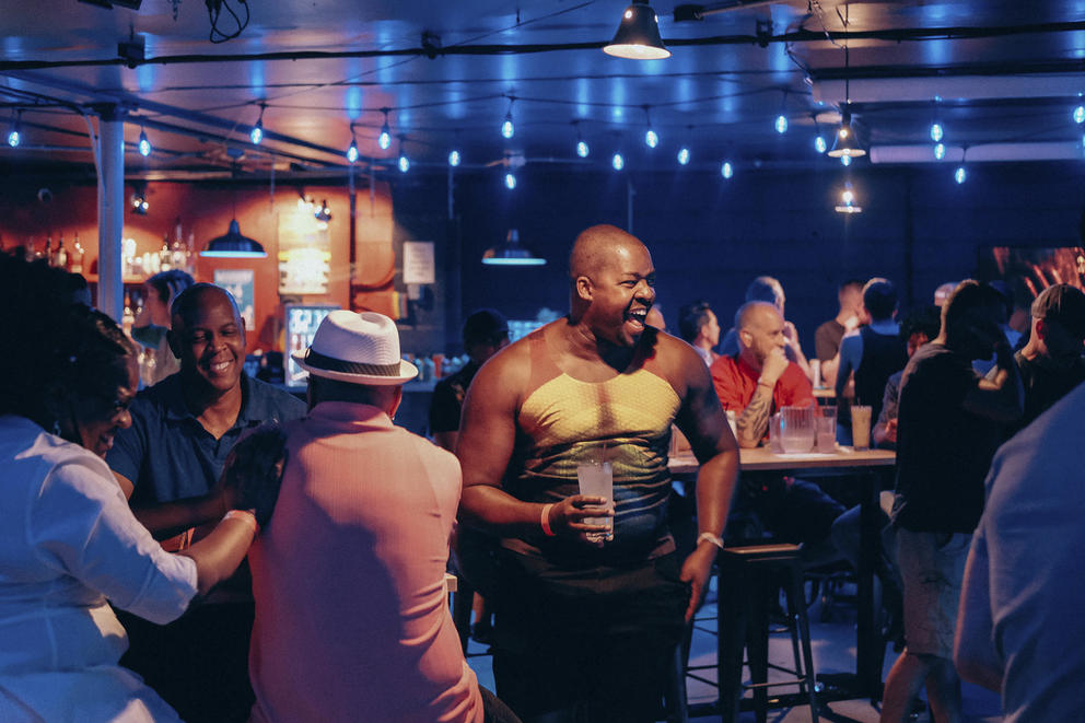 Richard Moore laughs with bar patrons