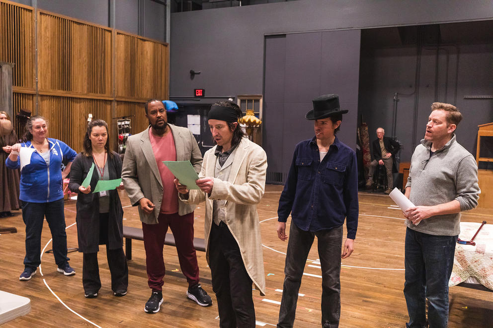 photo of a line of actors backstage at a play rehearsal