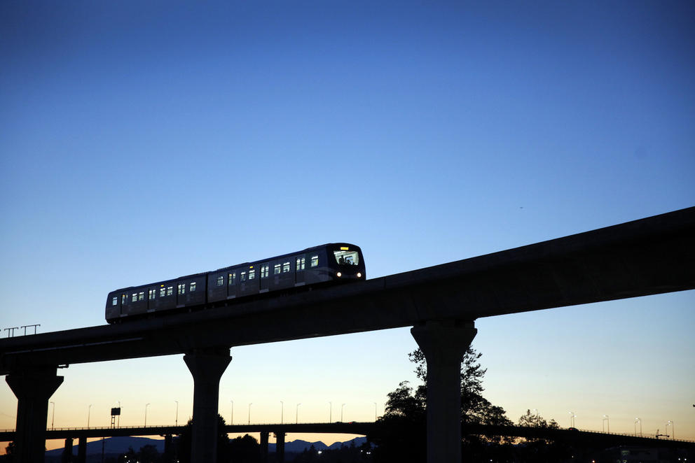 An elevated train under a darkening sky