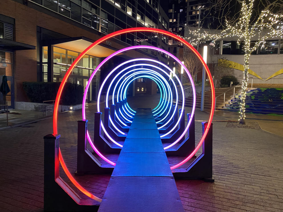 a human-scale spiral of rainbow colored light