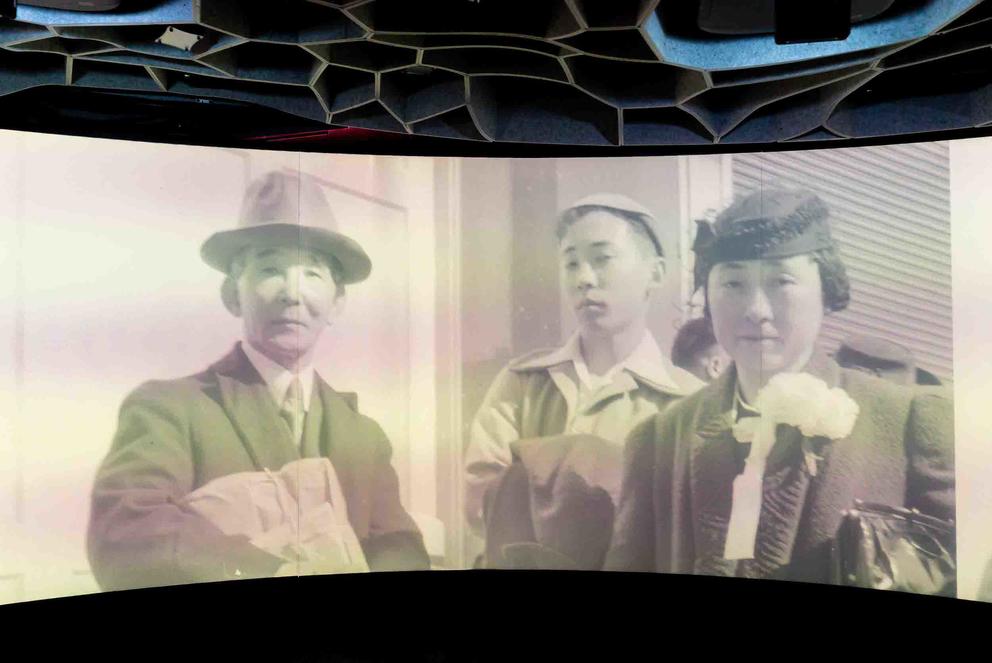 a photo of a screen showing a black and white photo of Japanese Americans in 1942