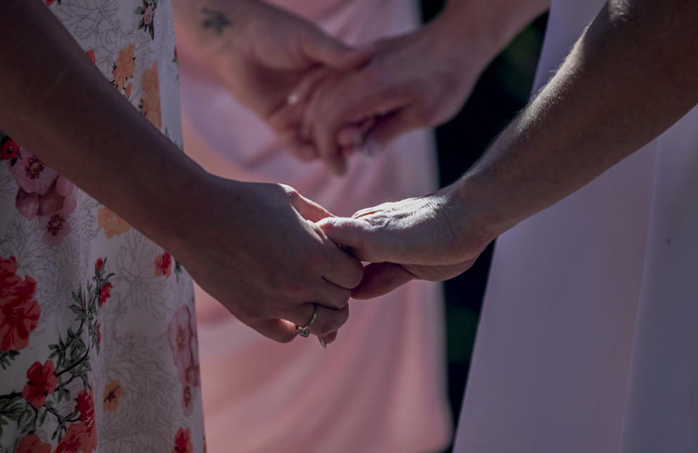 Jessica Johnson and Maia Sage hold hands