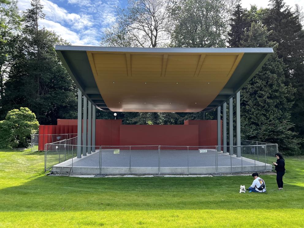 an outdoor stage with swooping roof