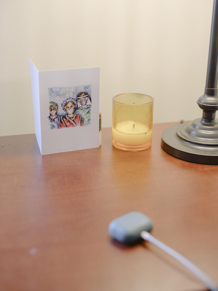 Greeting card and candle rest on a desktop