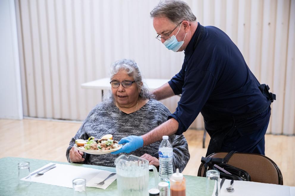 a senior is served a meal