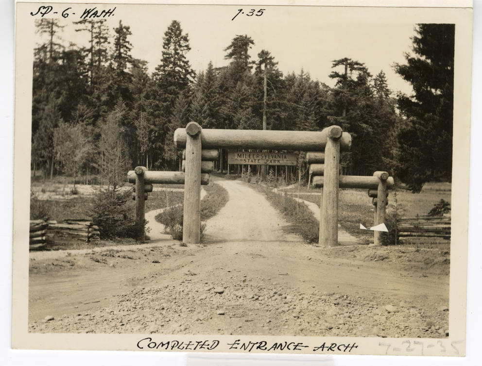 Archival image of a wooden arch spanning a road