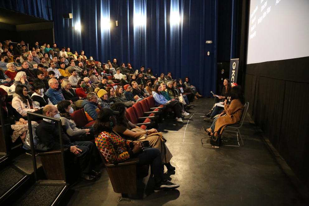 Attendees sit in a packed theatre for the Crosscut Origins premiere. 