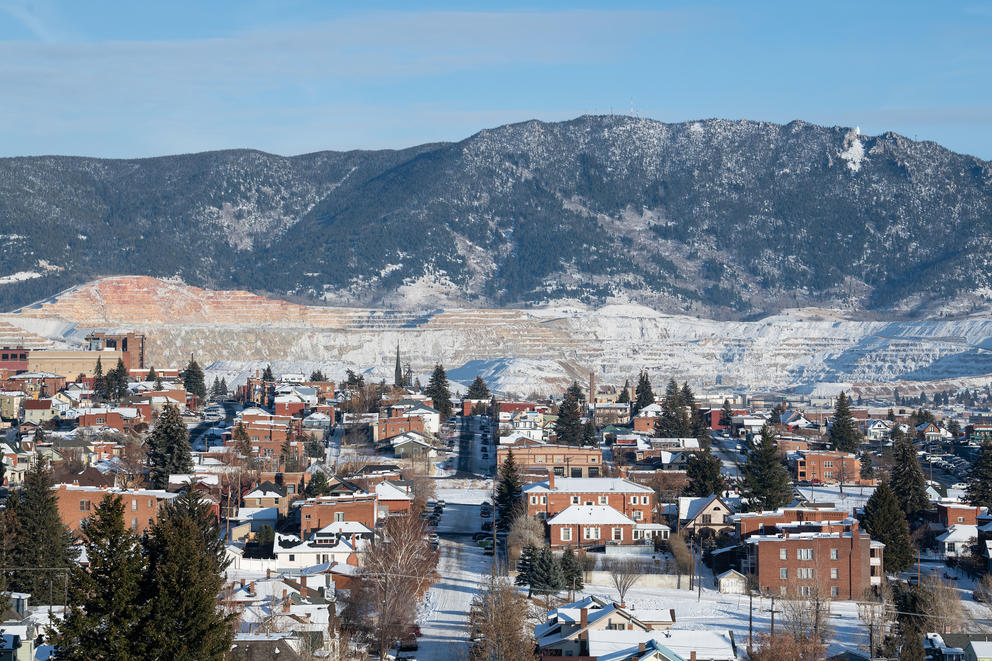 A view of the city of Butte, with the Berkley Pit in the background