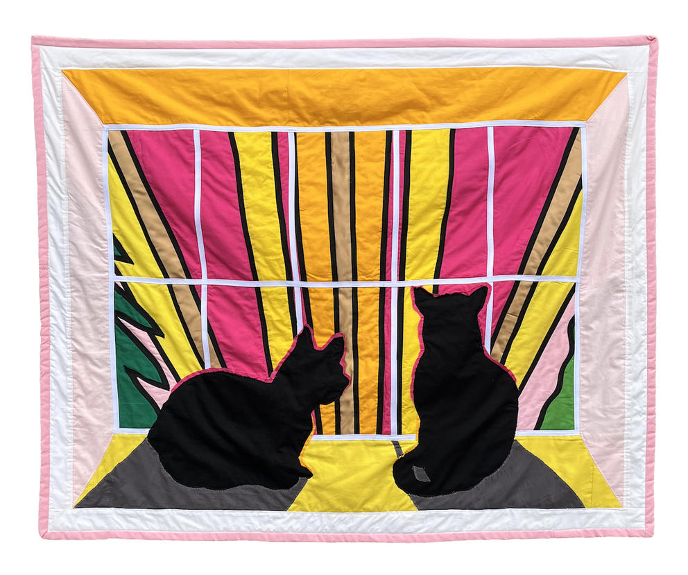 a hanging quilt with black cats in a windowsill looking out at a wildly colored sky