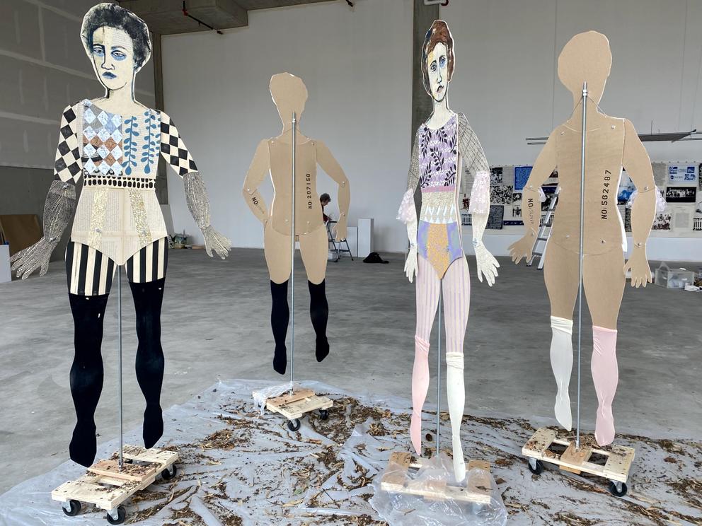 installation of 4 lifesize cardboard paper dolls