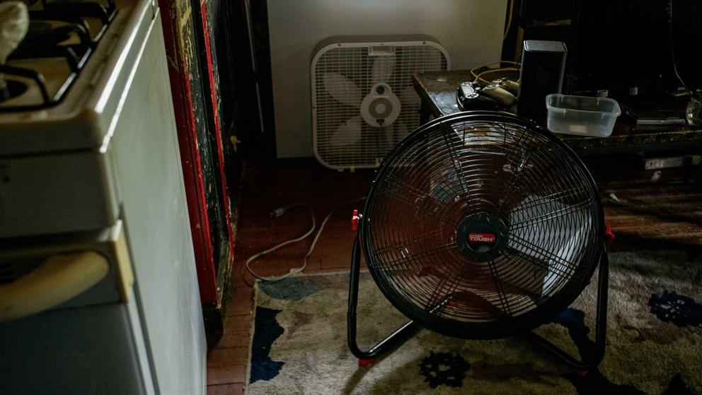 A fan cools the inside of a home during a heatwave.