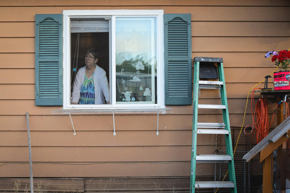 A woman is seen through the window of a mobile home