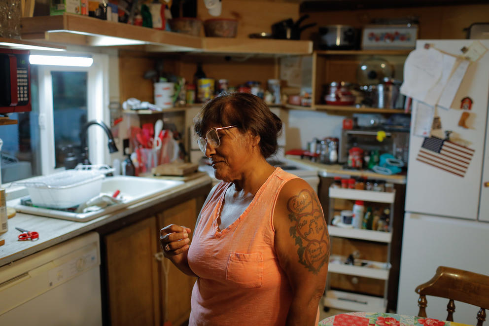 A portrait of a woman in her kitchen