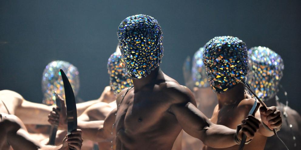 image of a group of dancers on stage wearing sparkly hoods