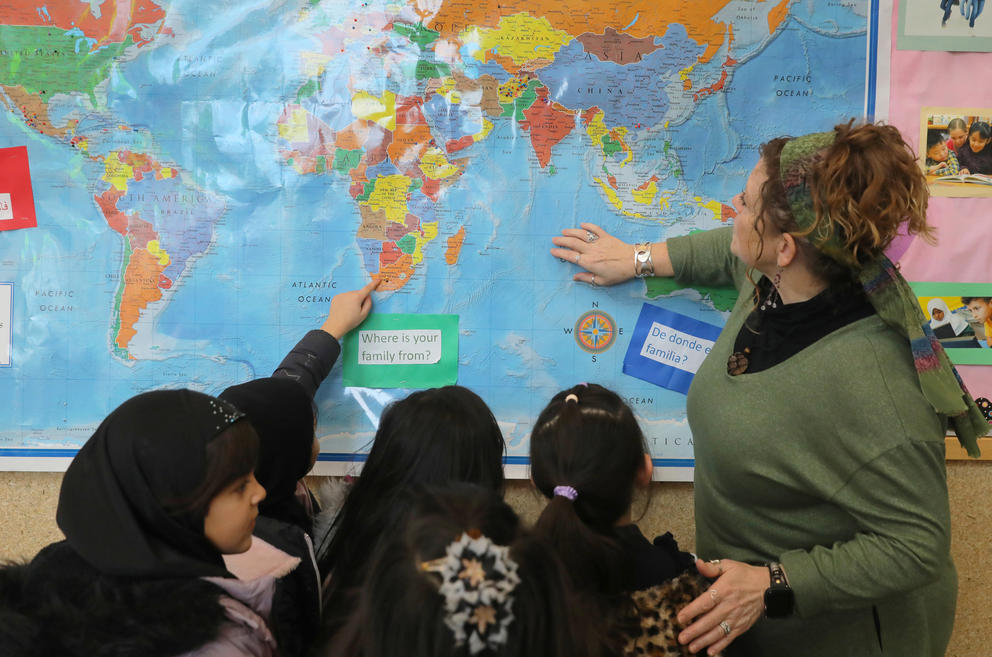 Parkside principal Bobbi Giammona asks a group of 2nd graders to point out on the world map where they are from. (Genna Martin/Cascasde PBS)