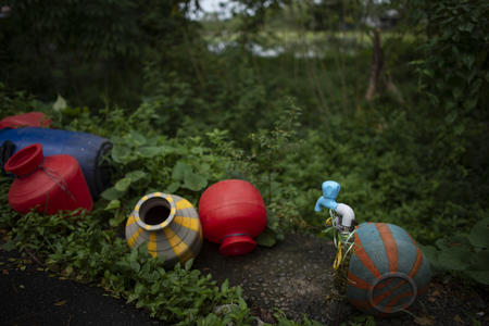 Colorful water jugs in the grass