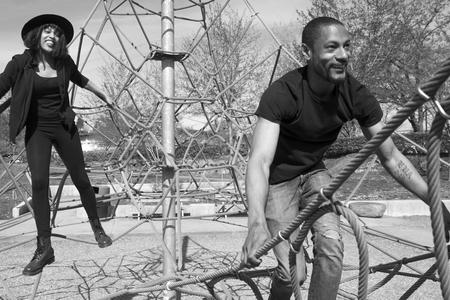 black and white photo of peope on playground