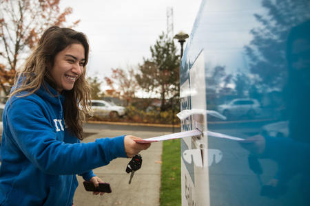 woman dropping off her ballot