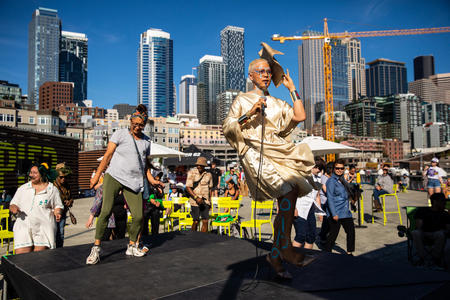 dancers perform in front of the downtown Seattle skyline