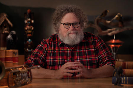 Kute Berger sitting at his desk on Mossback's den.