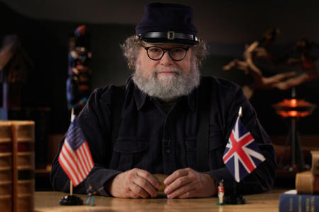 Knute Berger is sitting at his desk wearing a Civil War era hat.