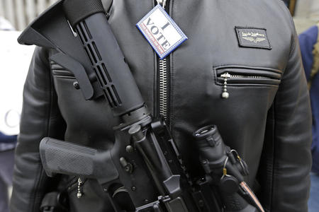 gun wearing man at a protest