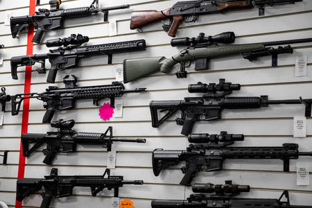 A photo of long guns on the wall of Bellevue Indoor Gun Range.