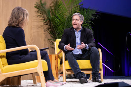 Two people on stage talking