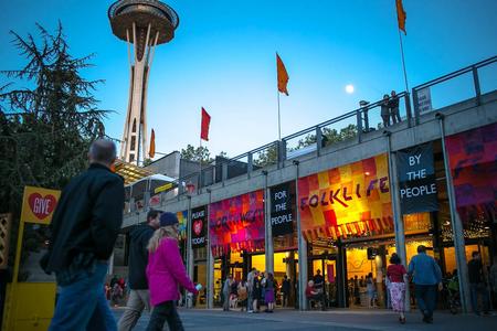 photo of a festival setting with the space needle in the background and banners reading Northwest Folklife