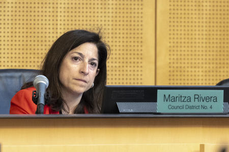 council woman martiza rivera sits behind a desk in seattle city hall